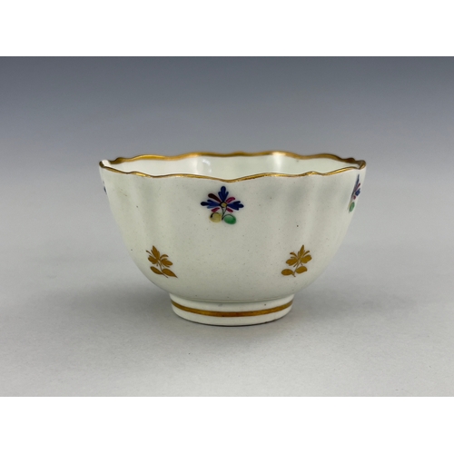 961 - A Caughley tea trio, circa 1790, reeded tea bowl and coffee cup, painted with French Sprigs in polyc... 