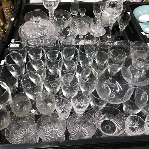 34 - A large collection of glass ware, to include cut glass bowl and cover, champagne glasses, three gobl... 