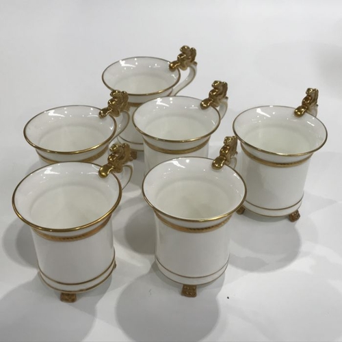 156 - A set of six Hammersley teacups, cylindrical form with gilded griffin handles, moulded gilt banded d... 