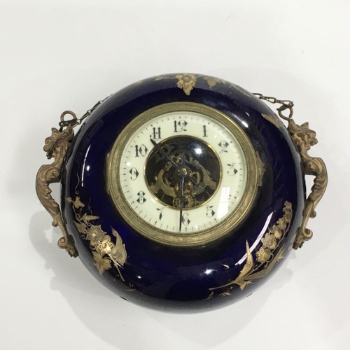 408 - A 19th Century French porcelain wall hanging circular clock, with gild metal mounts, 20cm diameter