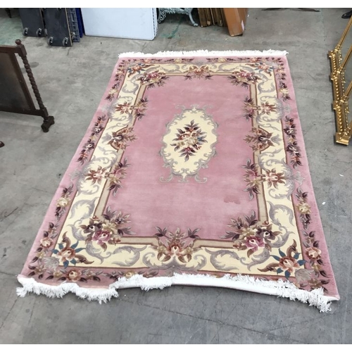 846 - Persian style wool carpet, peach ground with floral ivory medallions, 280cm x 182cm wide