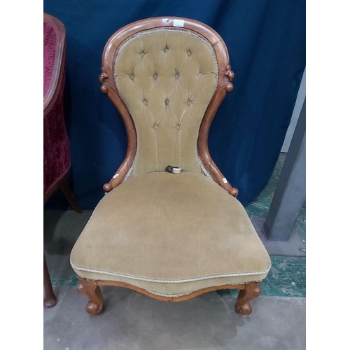 855 - A Victorian walnut framed nursing chair, button back, on carved cabriole scroll supports and brass c... 