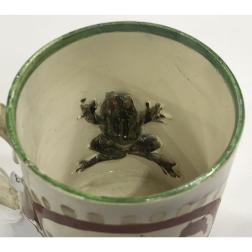 245 - A Sunderland lustre frog mug, cylindrical form with strap handle and stepped base, with printed and ... 