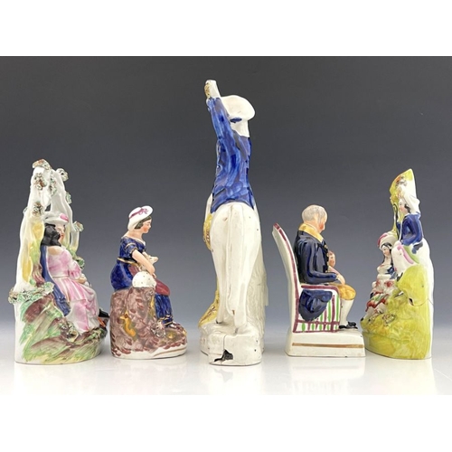 453 - A group of five 19th Century Staffordshire pottery and porcelain figures, to include lovers under an... 