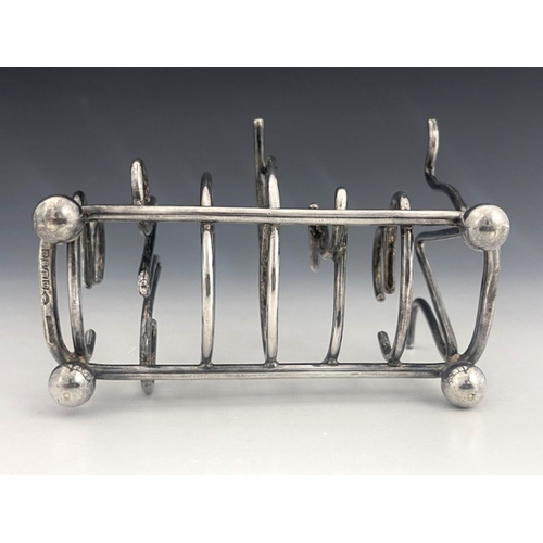 489 - A Victorian silver plated novelty toast rack, circa 1898, six division, the dividers in the form of ... 