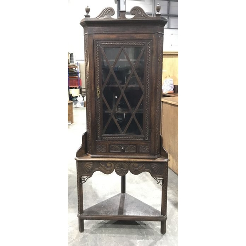 758 - A late 19th century carved oak corner cupboard and stand,  with single reeded astragal glazed door, ... 