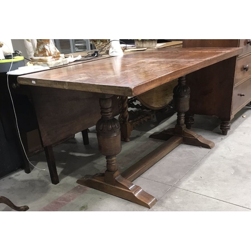 768 - An oak refectory style dining table, on trestle end supports, united by block stretcher, 152cm wide