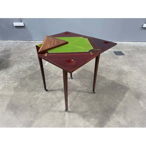 804 - An Edwardian mahogany, strung and crossbanded games table, circa 1910, retractable envelope top open... 