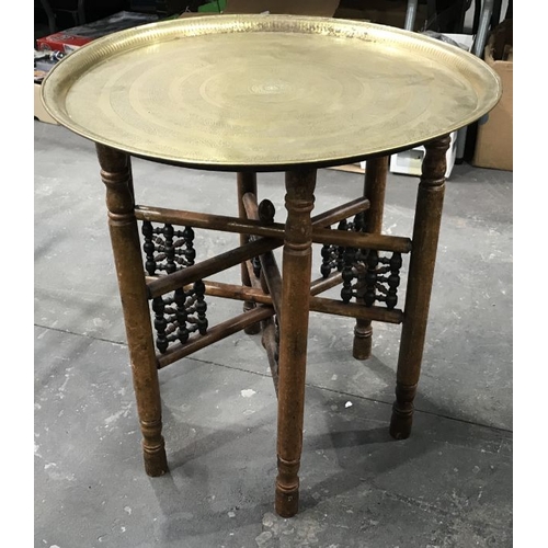 821 - A brass topped folding table, with chased concentric decoration, together with an Indian metal tray ... 