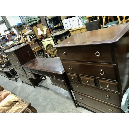 826 - A Stag Minstrel three piece bedroom suite, comprising two tall boys and a kneehole dressing table fi... 