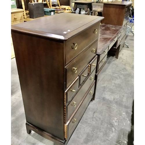 826 - A Stag Minstrel three piece bedroom suite, comprising two tall boys and a kneehole dressing table fi... 