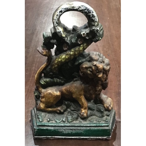 858 - A cast iron and painted door porter, circa 1850, modelled as a lion and coiled serpent amongst leave... 