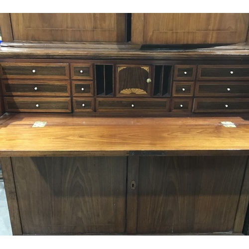 868 - A George III mahogany, boxwood and ebony strung secretaire bookcase, angled pediment flanked by urn ... 