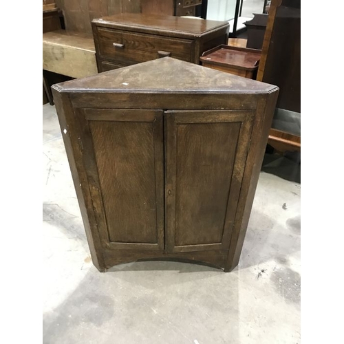 899 - An antique oak floorstanding corner cupboard, fitted two panelled doors, 98cm high x 77cm wide