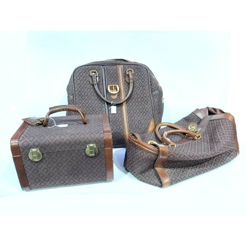 914 - A collection of Susan of London hand luggage, with woven open diamond work pattern on a chocolate br... 