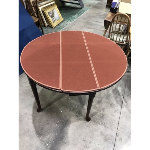 915 - A George III style mahogany circular drop flap table, 122cm maximum width