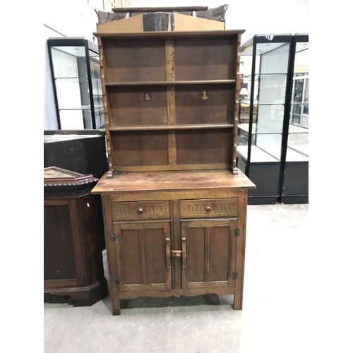 919 - A traditional oak dresser, 20th Century, plate rack, twin chip carved drawers to the frieze, twin cu... 