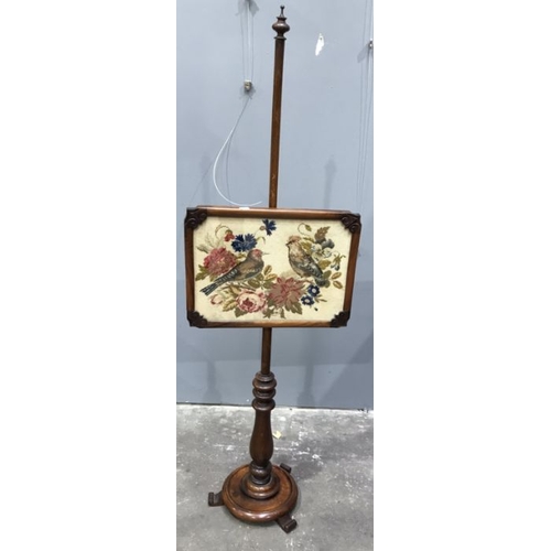 932 - A Victorian mahogany polescreen, circa 1860, glazed woolwork panel, circular plinth, 148cm high