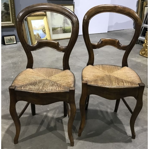 944 - A pair of 19th Century balloon back dining chairs, woven cane seats with serpentine front rails, Fre... 