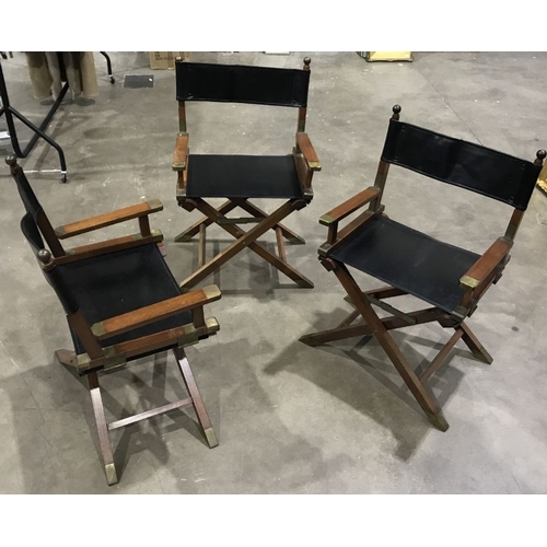 946 - A set of three hardwood Directors type folding armchairs, brass fittings, black leather seats and ba... 