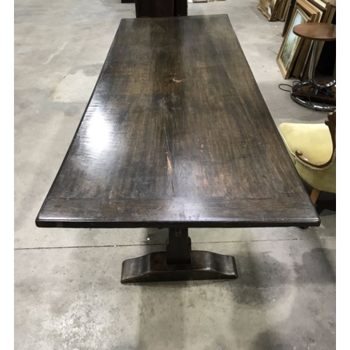 949 - An oak plank top refectory style table, on trestle style pegged supports, and stretcher, 213cm x 82c... 