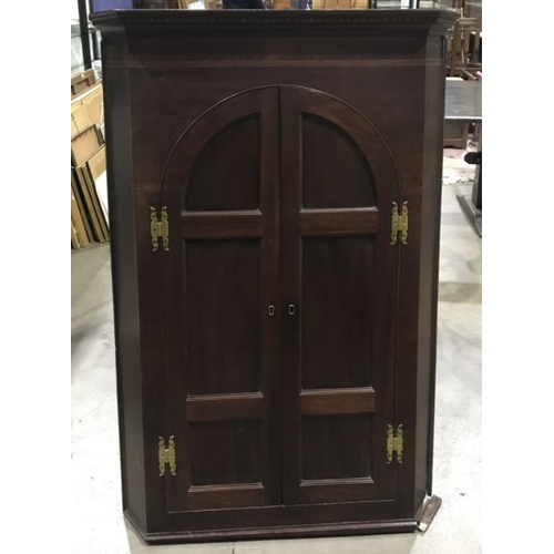 950 - A late 18th Century mahogany corner hanging cupboard, parquetry dentil cornice, canted corners, twin... 