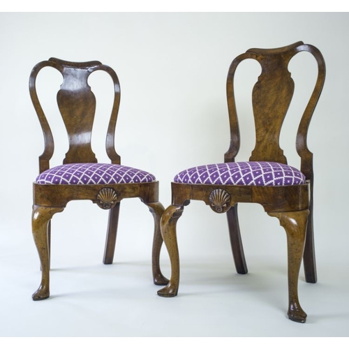 953 - A pair of early George II walnut side chairs, circa 1730, moulded top rails, pierced backs with vase... 