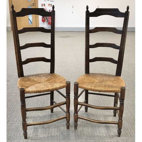 959 - A pair of oak ladderback rush seated chairs  (2)