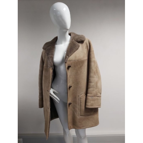 977 - A mink jacket and a shearling coat, to include a pastel mink jacket, featuring brown leather batwing... 