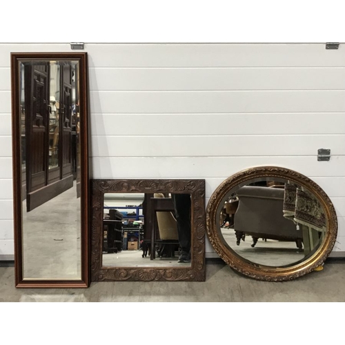 980 - Three wall mirrors including one carved wood, one bevelled edge and one oval gilt framed.