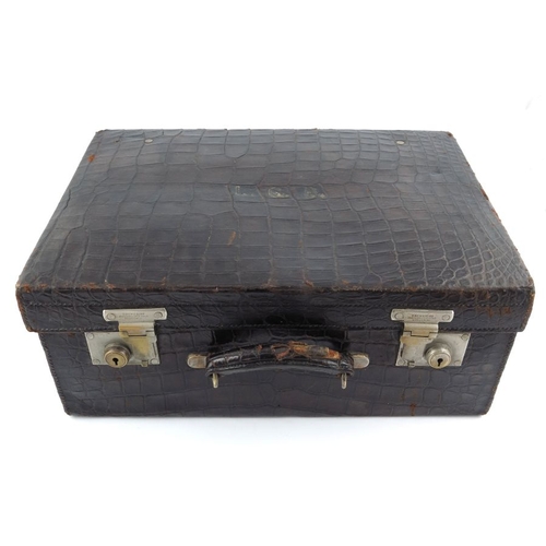 114 - ? A crocodile suitcase by Drew & Sons, the lid with initials 'L.C.B.', twin brass mounts stamped Dre... 