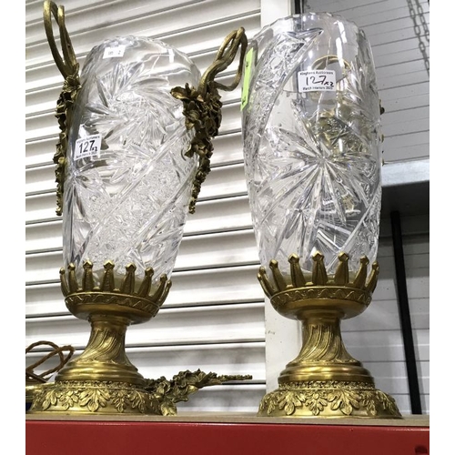 127 - A pair of crystal glass gilt metal mounted pedestal vases, rose cast and ribbon handles, wrythen mou... 