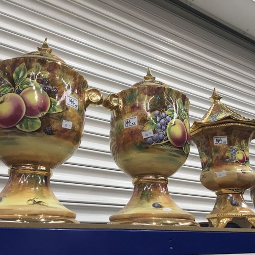 144 - A collection of fruit painted Baroness china vessels including a pair of large lidded urn vases and ... 