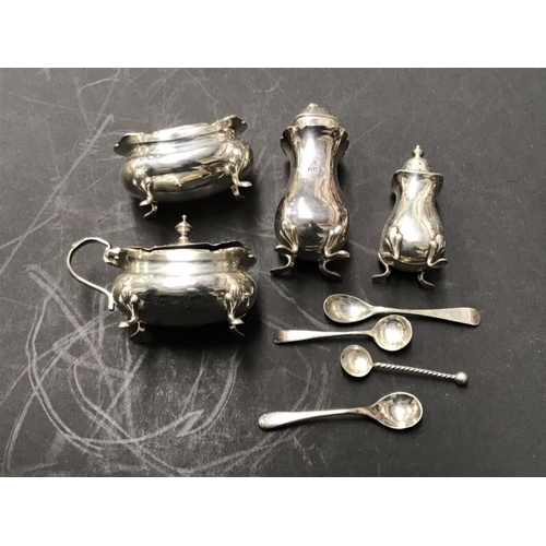 214 - A matched George V four piece silver and EPNS cruet set, various dates and maker's marks, on four fe... 