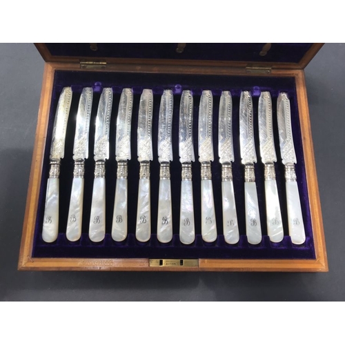 224 - A boxed set of silver plate and mother of pearl fruit eaters, including twelve knives and twelve for... 