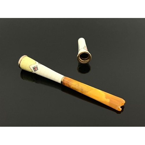 261 - A gold mounted enamelled and amber tipped cheroot holder, together with an enamelled cheroot tip, ea... 