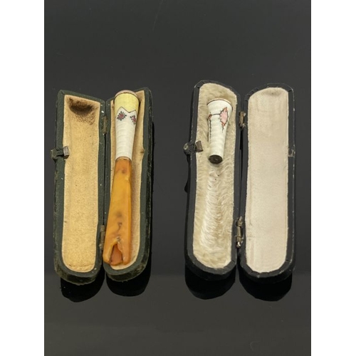 261 - A gold mounted enamelled and amber tipped cheroot holder, together with an enamelled cheroot tip, ea... 