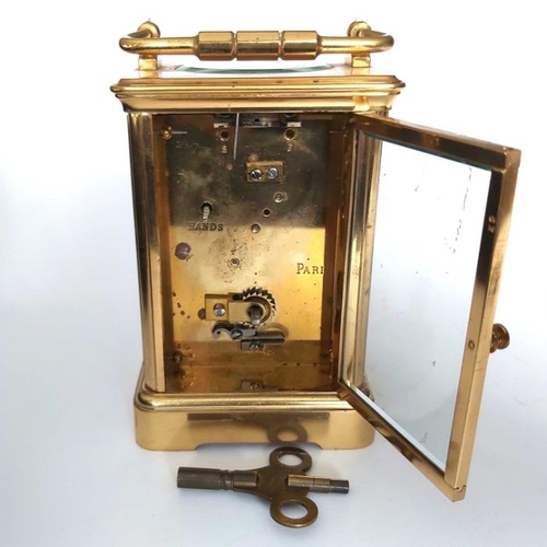 264 - A French gilt brass striking carriage clock, white dial with Roman numerals, carrying handle, 14cm h... 