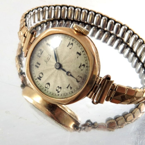 266 - Linit, a ladies 9 carat gold wrist watch, engine turned silvered dial with Arabic numerals, on plate... 