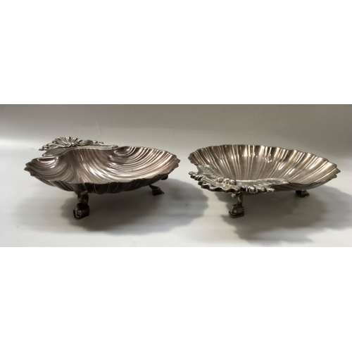 329 - A pair of Italian Olri plated shell form entree dishes, on three dolphin supports, 33.5cm wide (2)