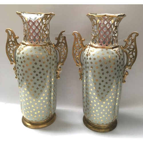 348 - A pair of early 20th century continental twin handled vases, cylindrical and reticulated form, paint... 