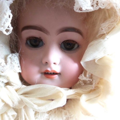 403 - A French bisque head doll, sleeping brown eyes, painted open mouth and exposed teeth, composite join... 