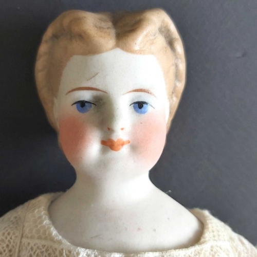 406 - An 19th century china shoulder head doll, pierced ears, composite jointed body, in white linen dress... 