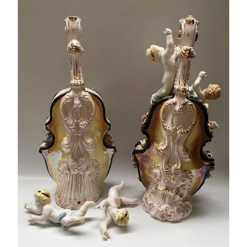 410 - A pair of Italian porcelain moulded cellos with floral encrustations and modelled cherubs, 67cm high... 