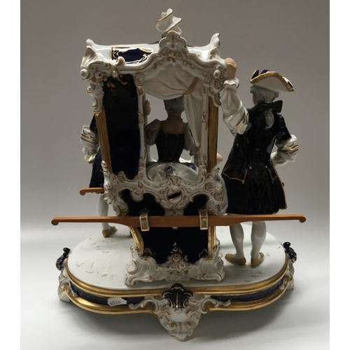 415 - A Royal Dux porcelain figure group, Sedan chair with figures and recumbent dog, 39cm high