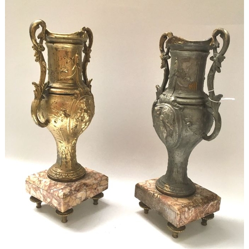 429 - A pair of cast art metal pedestal vases, baluster twin handled form, on square chamfered marble base... 