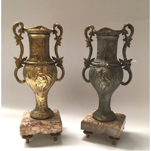 429 - A pair of cast art metal pedestal vases, baluster twin handled form, on square chamfered marble base... 