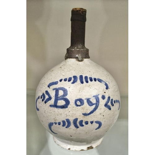 437 - A Delft type blue and white faience bottle, spherical with metal neck, painted Boy, and a green glas... 