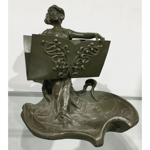 454 - A patinated art metal figural letter holder, in the art Nouveau style, modelled as a woman holing an... 