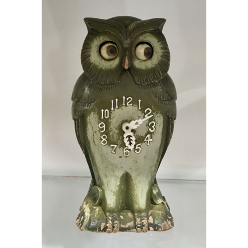 466 - A Continental owl clock, with Arabic numerals, 24cm high